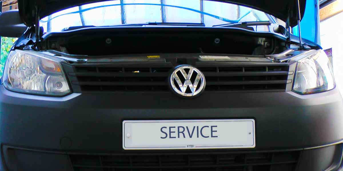 close up of a volkswagon car with bonnet up getting an annual vehicle service